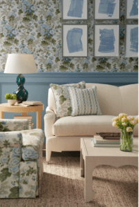 A living room with blue and white floral wallpaper.